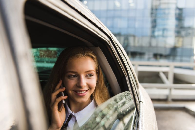 car passenger talking on phone