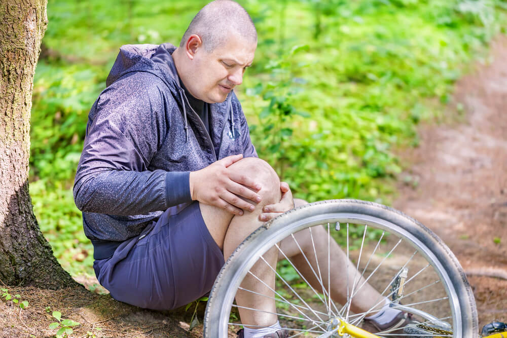a man holding his injured knee