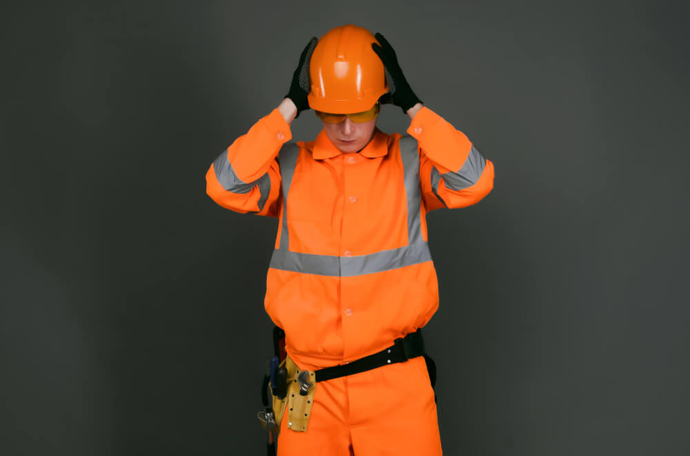 construction worker wearing a bright orange high-visibility uniform