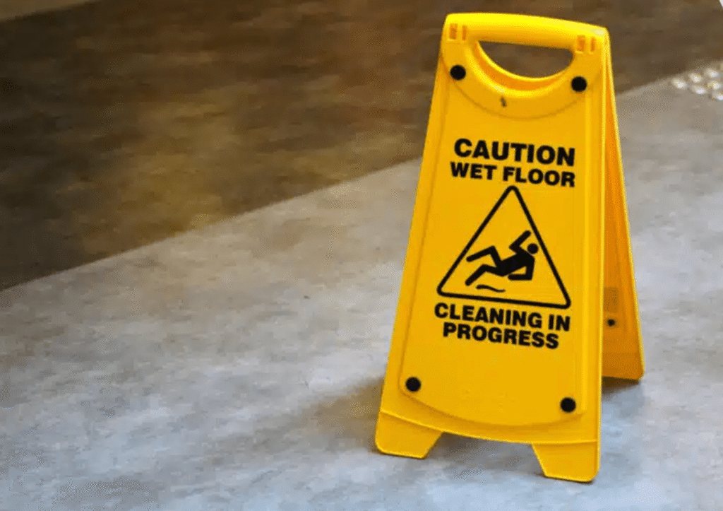 bright yellow sign with a slipping hazard symbol