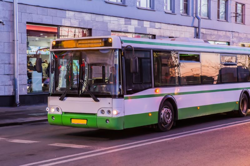 city bus on the road in the evening