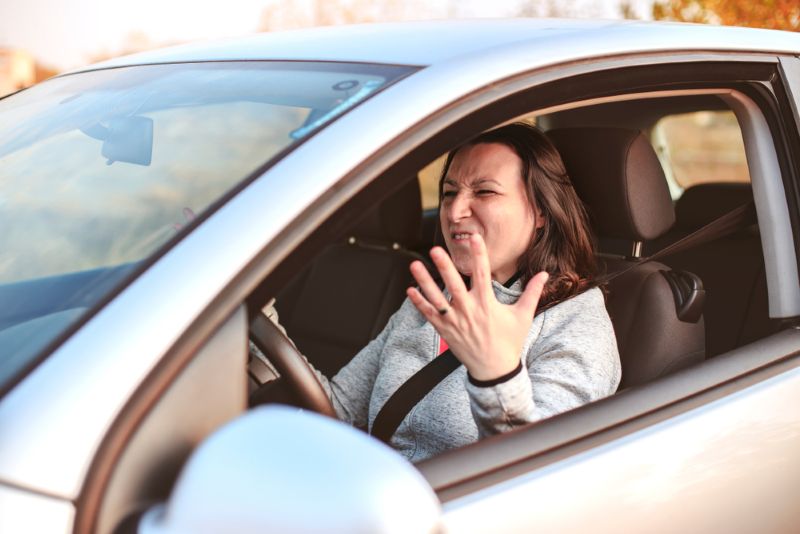 upset woman behind the wheel of her car