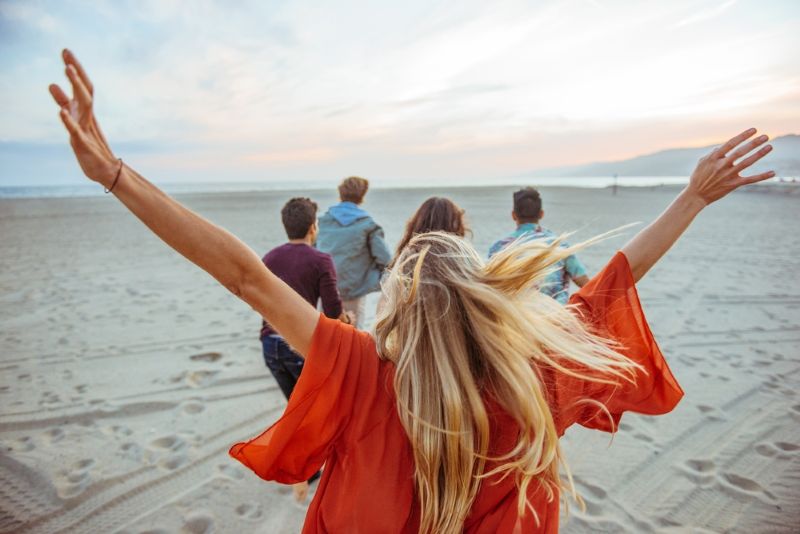 group of friends walking around the beach