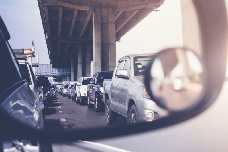 busy line of traffic in a car's side mirror
