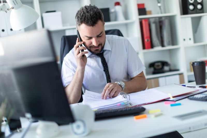 Insurance agent sitting at desk reviewing paperwork