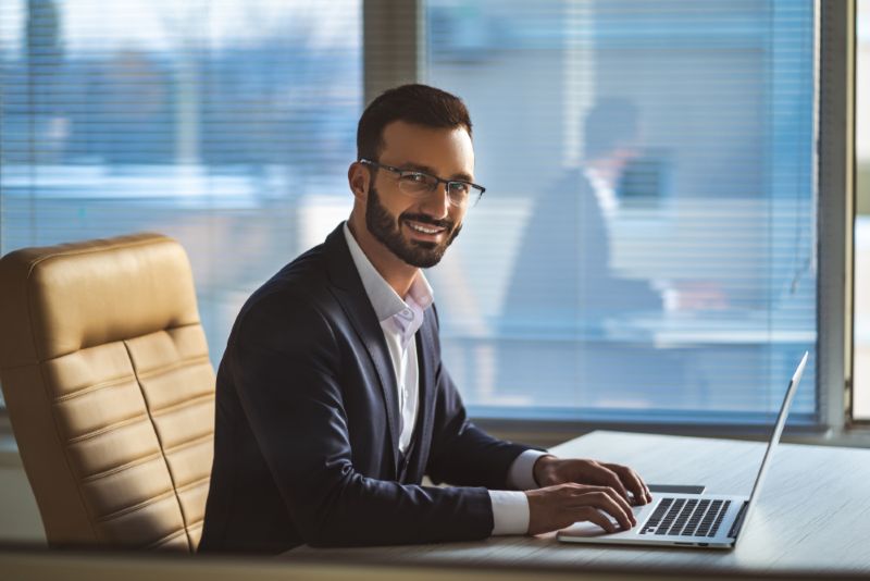Businessman smiling while working at his desk